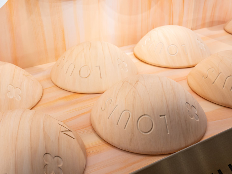 Close-up of embossed monogram detailing on a sculpted display piece